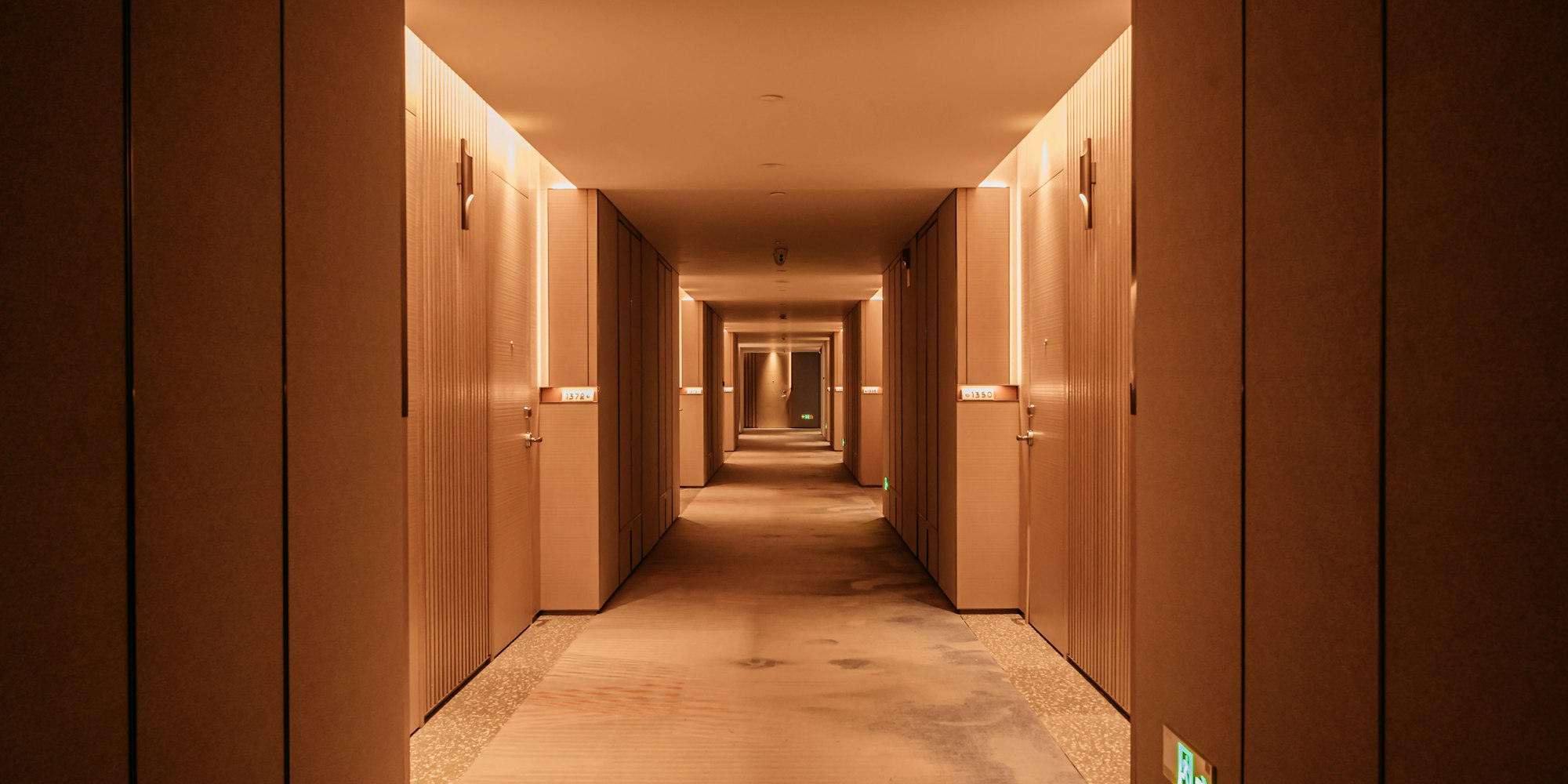 A hotel corridor of closed doors